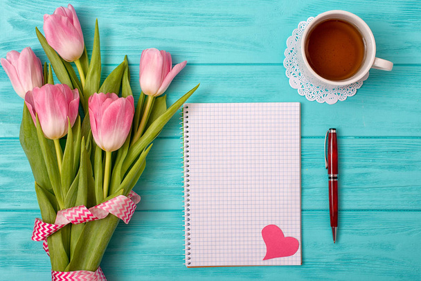 Valentine's Day background with bouquet of tulips and an empty notebook for romantic entries. - Zdjęcie, obraz