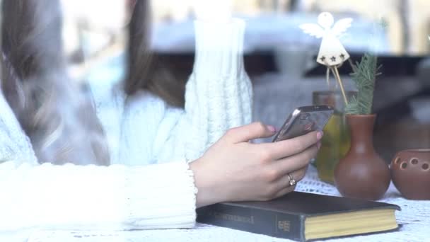Beautiful Young Woman Using Smartphone In Cafe, View Through The Window - Video