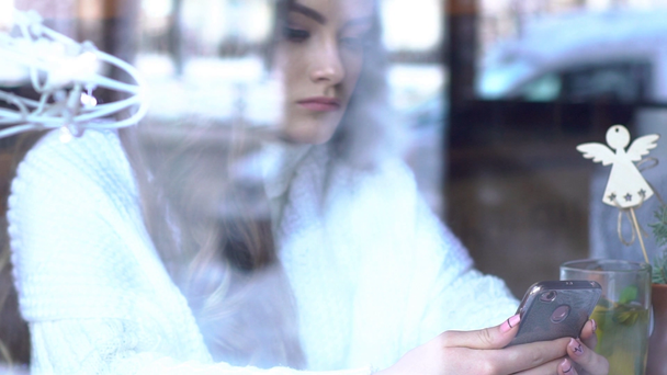 Slow Motion Smartphone Girl Using App On Phone In Cafe.view Through Window - Кадри, відео