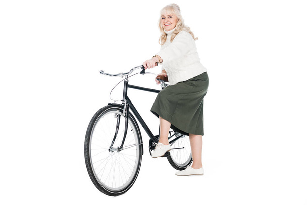 cheerful senior woman riding bicycle isolated on white - Photo, Image