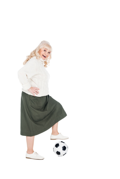 smiling senior woman playing football isolated on white - Fotografie, Obrázek