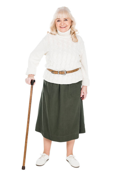 happy retired woman standing with walking cane isolated on white - Zdjęcie, obraz