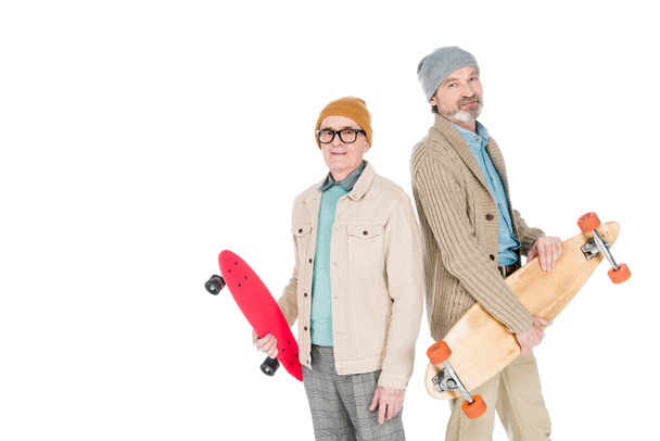 stylish senior men holding skateboards isolated on white - Fotó, kép