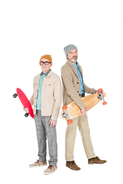 stylish retired men holding skateboards isolated on white - Photo, Image