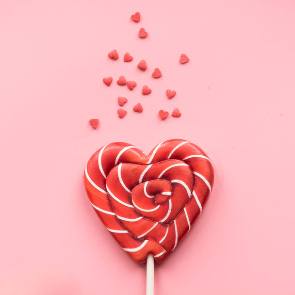 Valentine's card. Lollipops candy as heart on pink background. Funny concept. - Foto, Bild