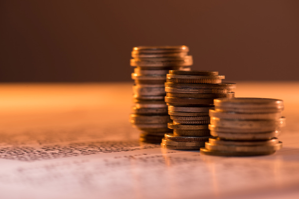 selective focus of coins stacks on text document and blurred background - Foto, Bild