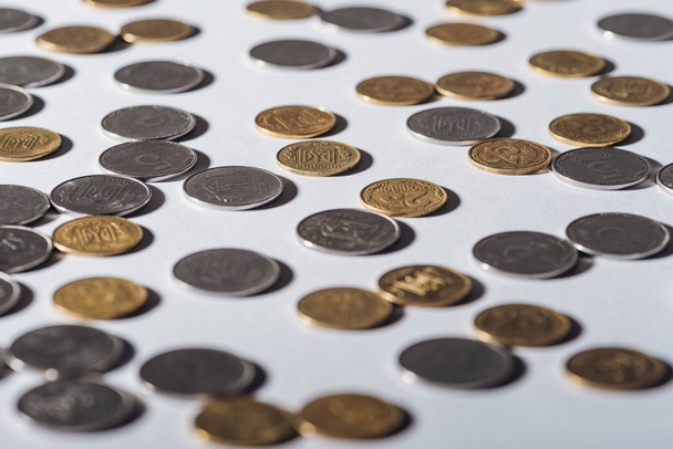 selective focus of ukrainian silver and golden coins on grey background - Photo, Image