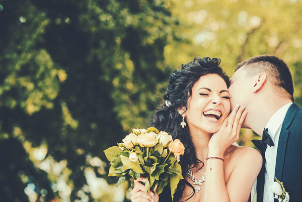 Couple in love kiss and smile on wedding day. Couple in love on summer outdoor - Foto, Imagem