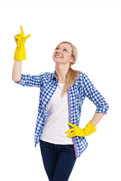 Smiling female cleaner pointing up - Fotó, kép