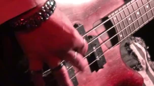 bass guitar in live action at a concert - rack focus - close up - Felvétel, videó