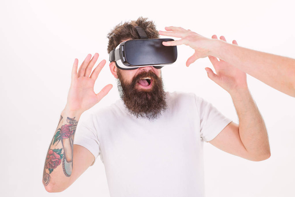 Man with beard in VR glasses, white background. Hipster use modern technologies for entertainment. Guy with head mounted display interact with hand in virtual reality. Virtual reality concept - Fotografie, Obrázek