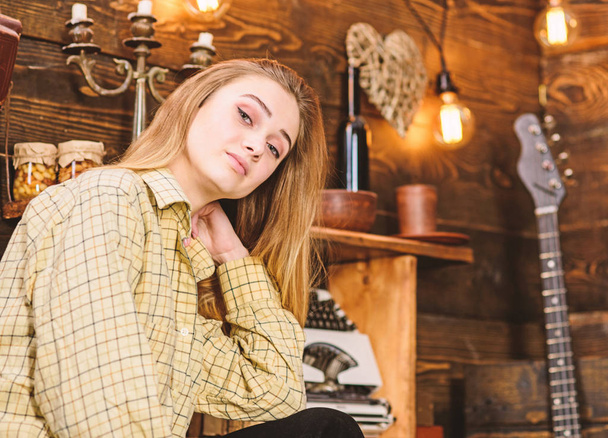 Girl tomboy spend time in house of gamekeeper. Tomboy concept. Lady on dreamy face in plaid clothes looks cute and casual. Girl in casual outfit in wooden vintage interior - Photo, Image