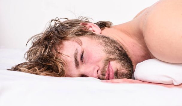 Guy bearded macho relax in morning. Man attractive macho relax and feel comfortable. Simple tips to improve your sleep. Total relax concept. Man unshaven bearded face sleep relax or just wake up - Foto, Imagen