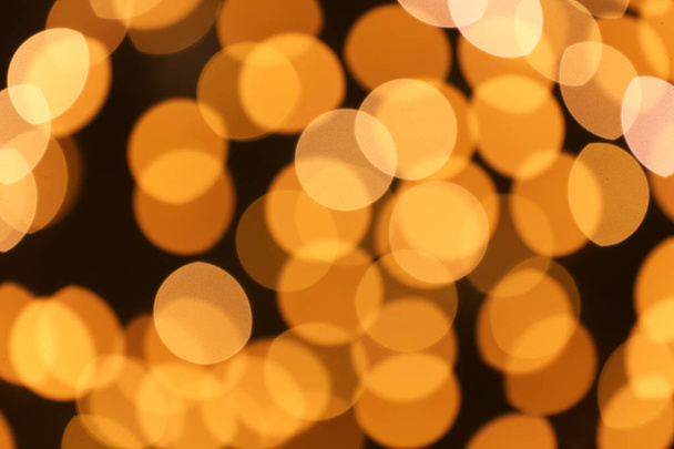 Beautiful golden lights on dark background. Bokeh effect - Valokuva, kuva