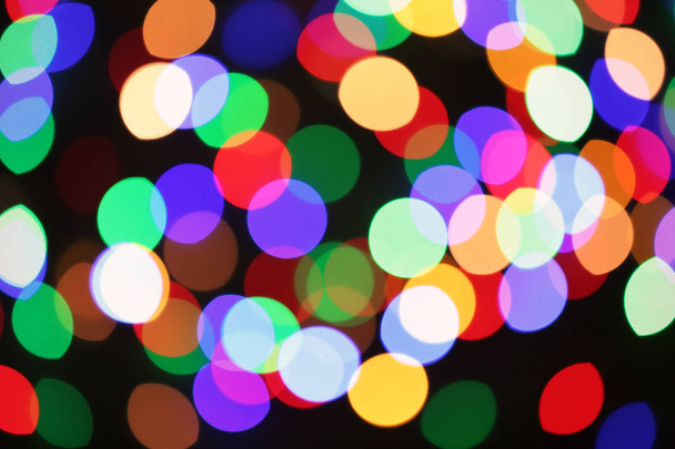 Beautiful colorful lights on dark background. Bokeh effect - Valokuva, kuva