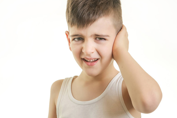 Studio shot of young boy with ear pain. Can not hear you concept. - Photo, Image