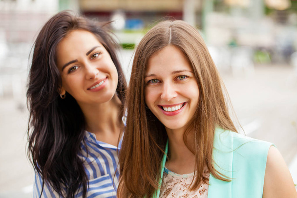 Close up, Two happy young women in summer street, outdoors - Фото, изображение