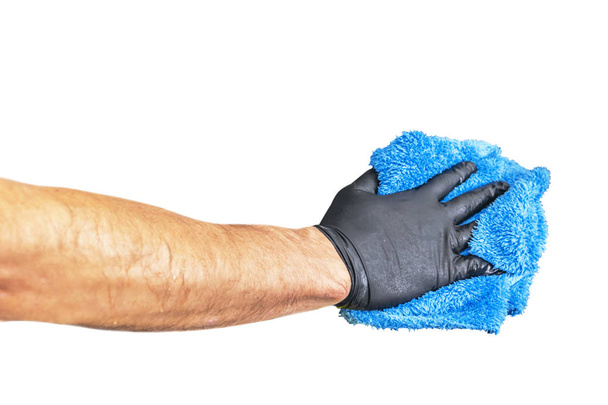 Washing concept. A male man hand with cloth isolated on white background. Worker cleaning. Cleaning with cloth, foam and brush. Cleaning concept. Hand in black protective rubber glove  - Foto, immagini