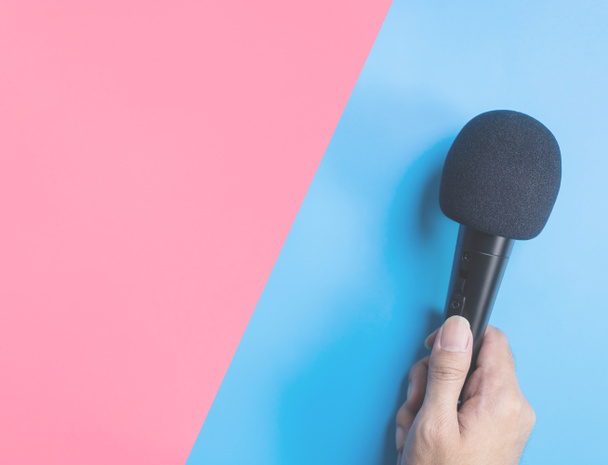 Black microphone on blue pink background for music concept - Foto, afbeelding
