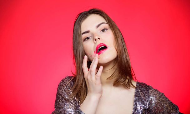 Beauty tips. Girl makeup lips posing over red background. Makeup for party. Resistant products for excellent make up. Resistant lipstick. Woman with spoiled makeup. Makeup and cosmetics concept - Photo, image
