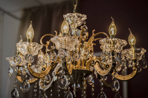 Beautiful art objects. Beautiful view, background, landscape, panorama of the old and pompous crystal and metal chandeliers, lamps and lanterns in retro and vintage style. - Foto, immagini