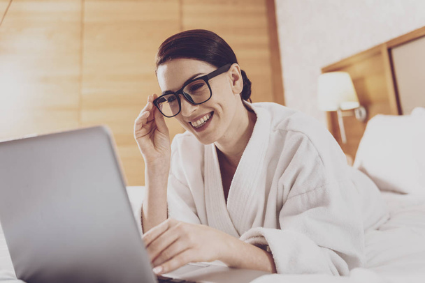 Young businesswoman in glasses using laptop - Fotó, kép