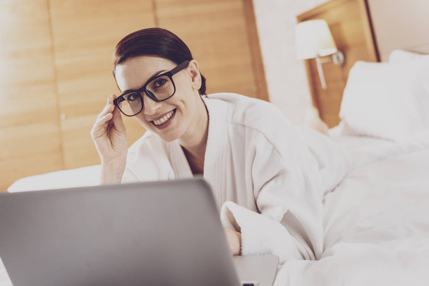 Cheerful woman spending time with laptop - Photo, Image