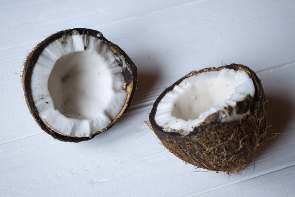 Coconut on a white wooden background. - Zdjęcie, obraz