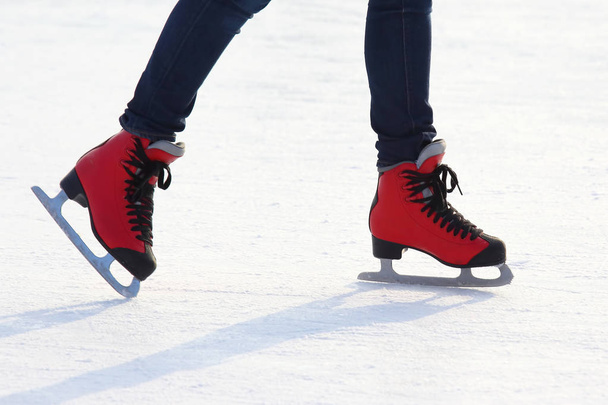 feet in red skates on an ice rin - Photo, Image