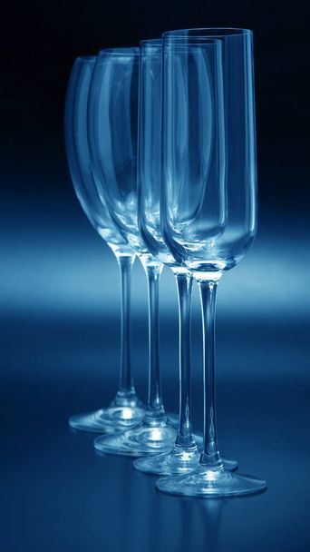 Four wine glasses on a dark background close-up - Foto, afbeelding