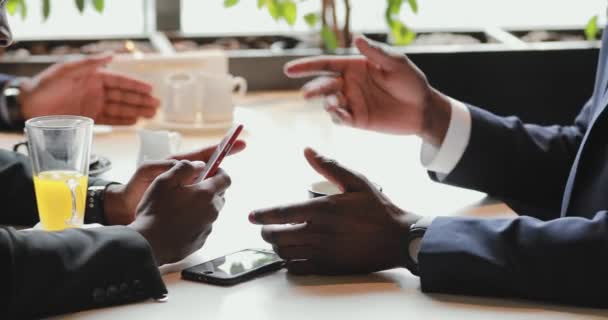 Hands of african businessmen talking in a cafe - Felvétel, videó