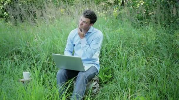 Businessman working outdoors with a cup of coffee - Footage, Video