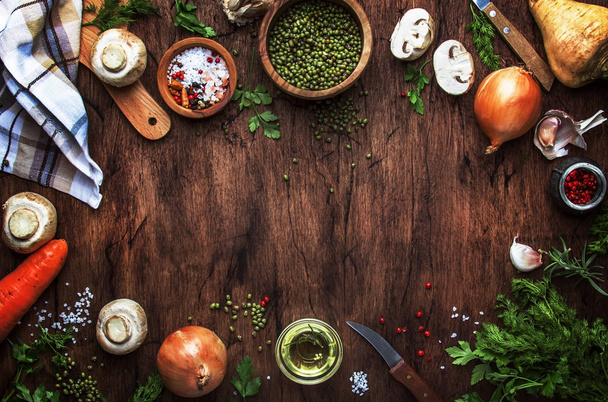 Ingredients for cooking green lentils with mushrooms and vegetables, spices and herbs, vintage wooden kitchen table background, place for text. Vegan or vegetarian food, clean food concept. Top view, flat lay  - Valokuva, kuva