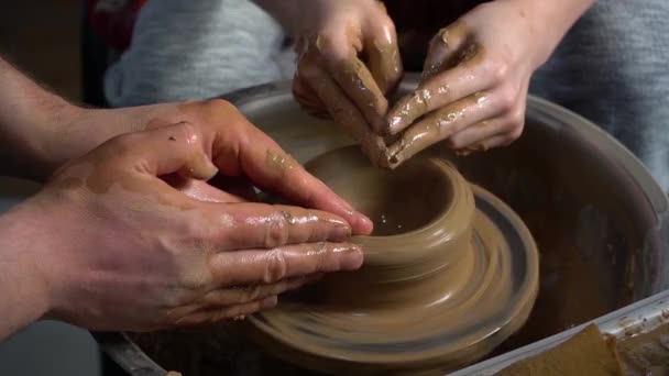 Teaching pottery to children. The teacher gives a master class in modeling - Footage, Video