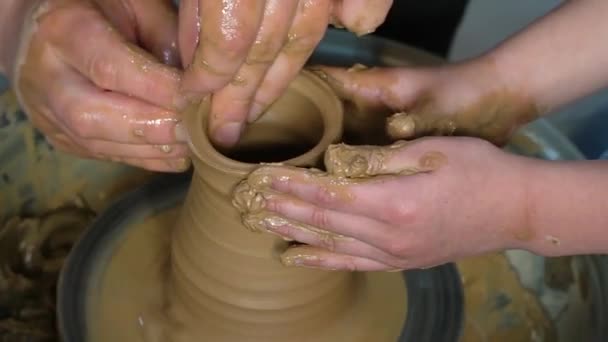 Teaching pottery to children. The teacher gives a master class in modeling - Footage, Video