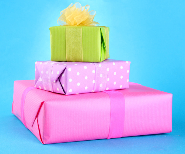 Bright gifts with bows on blue background - Φωτογραφία, εικόνα