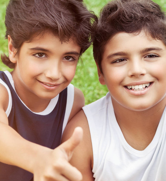 Closeup portrait of a two happy smiling boys, best friends with pleasure spending time together outdoors, enjoying holidays in the summer cam - Photo, Image