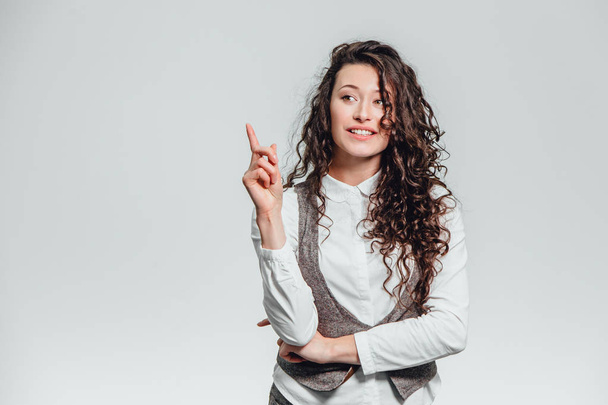 Portrait of attractive business woman on white background. With plenty of copy space. With a beautiful curly hair - Photo, Image