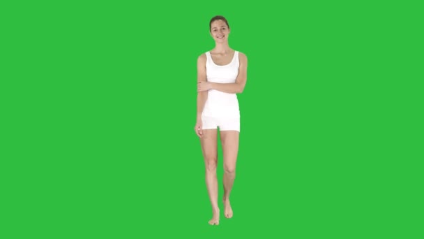 Siling happy charming fitness girl walking on a Green Screen, Chroma Key. - Footage, Video