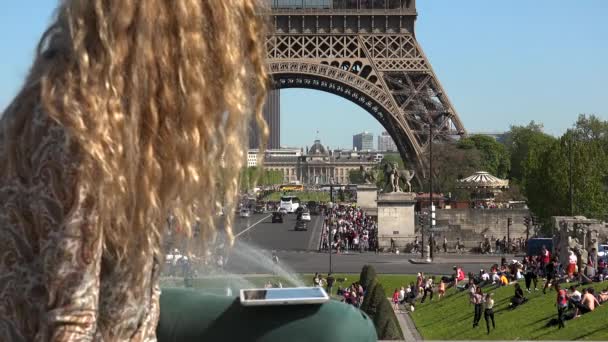 Beautiful woman with hair in the wind captures moments and memories near the Eiffel Tower - Footage, Video