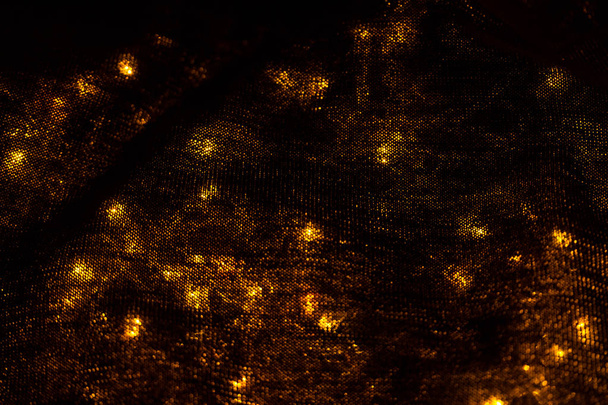 lights background image. blurred lights under black material - Foto, afbeelding