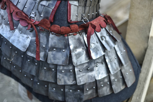 Beautiful art objects. Beautiful background, view, landscape, panorama of the reconstruction of the knightly tournament, metal armor dressed on a knight on a summer day in nature. - Foto, imagen