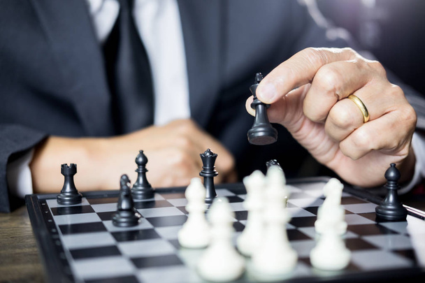hand of businessman moving chess figure in competition board game for development analysis, strategy idea management or leadership concept - Фото, изображение
