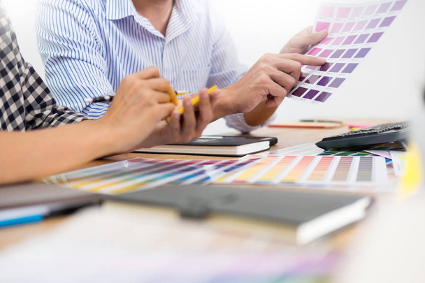 suunnittelija graafinen luovuus työskentelevät yhdessä väritys käyttäen grafiikka tabletti ja kynä pöydällä kollegansa
  - Valokuva, kuva