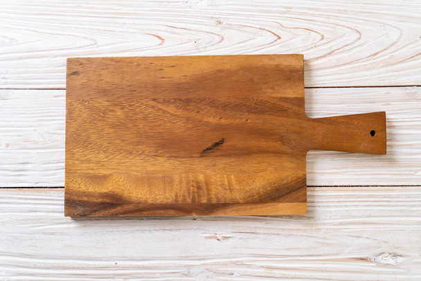 empty cutting wooden board with kitchen cloth on wood background - 写真・画像