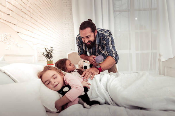 Delighted bearded man caring about his daughters - Photo, Image