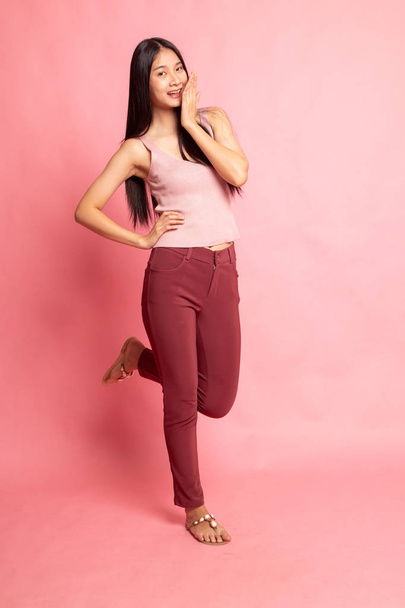 Full body of happy beautiful young asian woman on pink background - Foto, imagen