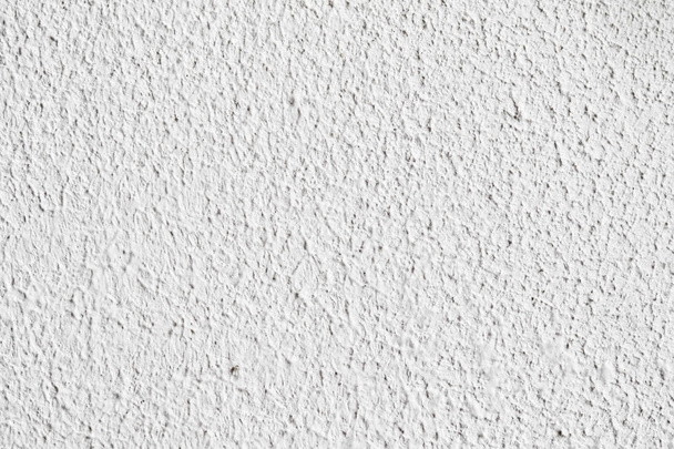 Achtergrondstructuur. Witte betonnen muur. Kleine scheuren op het oppervlak. - Foto, afbeelding