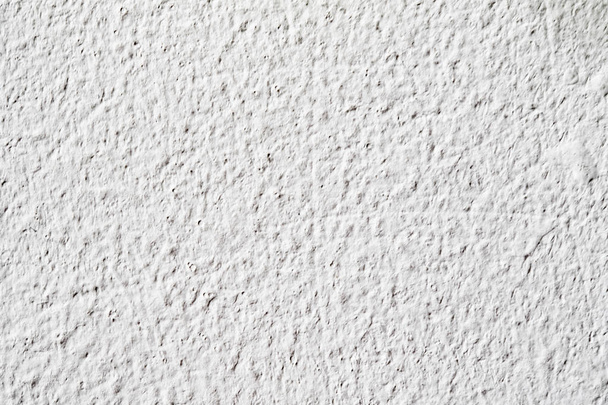 Textura de fondo.Muro de hormigón blanco. Pequeñas grietas en la superficie
. - Foto, Imagen