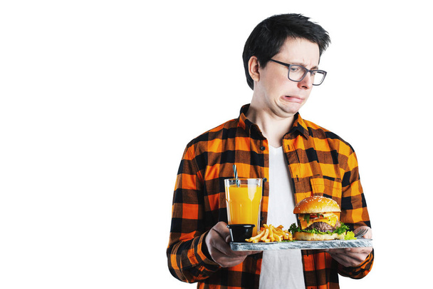 Handsome man refusing unhealthy burger against white background. Diet concept. With copy space for text. Isolated. - Photo, Image